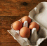 open-egg-carton-for-six-eggs-containing-four-brown-eggs-on-a-rough-rustic-brown-wooden-table - News102.Ru