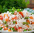 appetizing-healthy-rice-with-vegetables-in-white-plate-on-a-wooden-table - News102.Ru