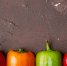 horizontal-view-peppers-maroon-background - News102.Ru