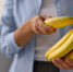 front-view-woman-holding-bananas - News102.Ru