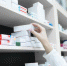 closeup-view-of-pharmacist-hand-taking-medicine-box-from-the-shelf-in-drug-store - News102.Ru