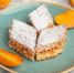 front-view-delicious-cake-slices-with-sugar-powder-fresh-peaches-inside-plate-table-cake-biscuit-sugar-sweet-pastry-bake - News102.Ru