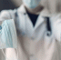 doctor-hold-the-antiseptic-and-masks-in-his-hand - News102.Ru